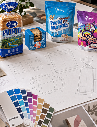 Packaging design process with dielines, color swatches, stock samples, and prototypes
